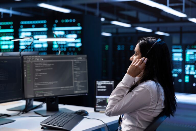 IT support specialist monitoring systems and providing remote assistance in a modern server room for managed IT services and network support.